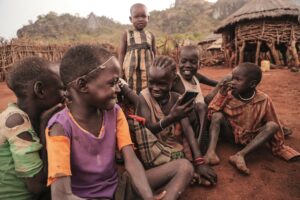 Children in Uganda listening to a MegaVoice audio Bible