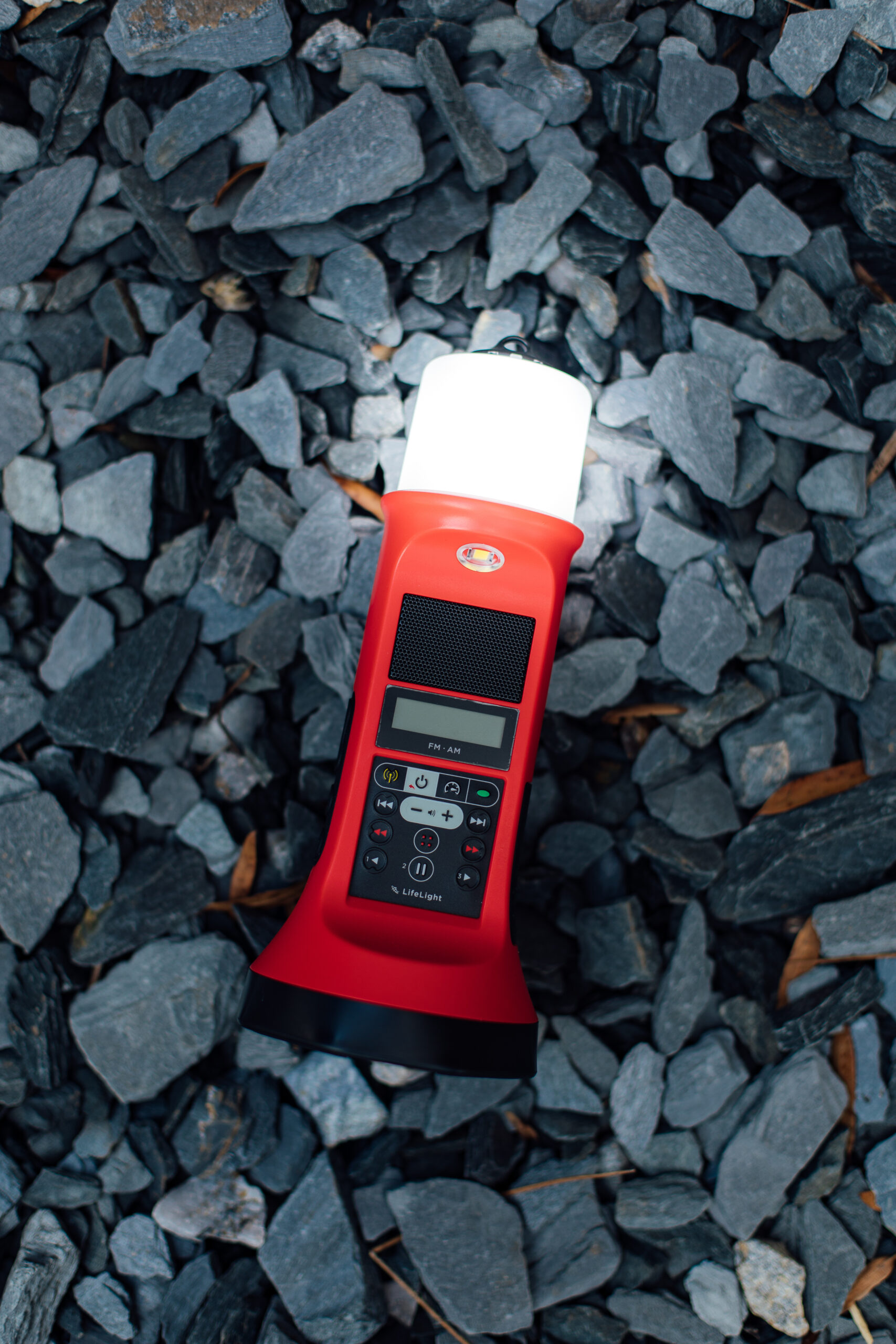LifeLight audio Bible lantern lit up on some rocks