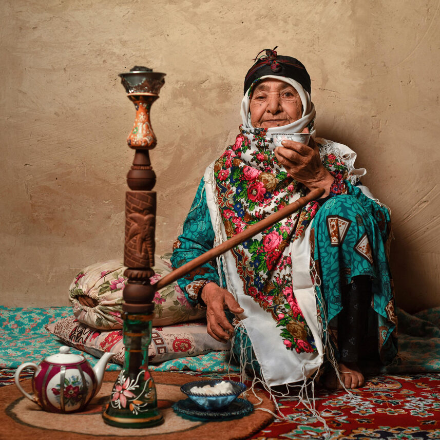 Persian woman sitting on a rug