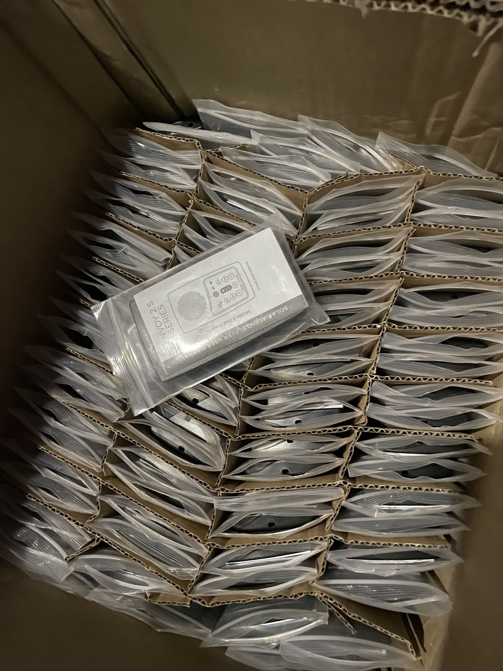 Boxes of packaged audio Bible players ready to ship