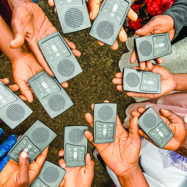 Group of hands holding MegaVoice audio Bibles